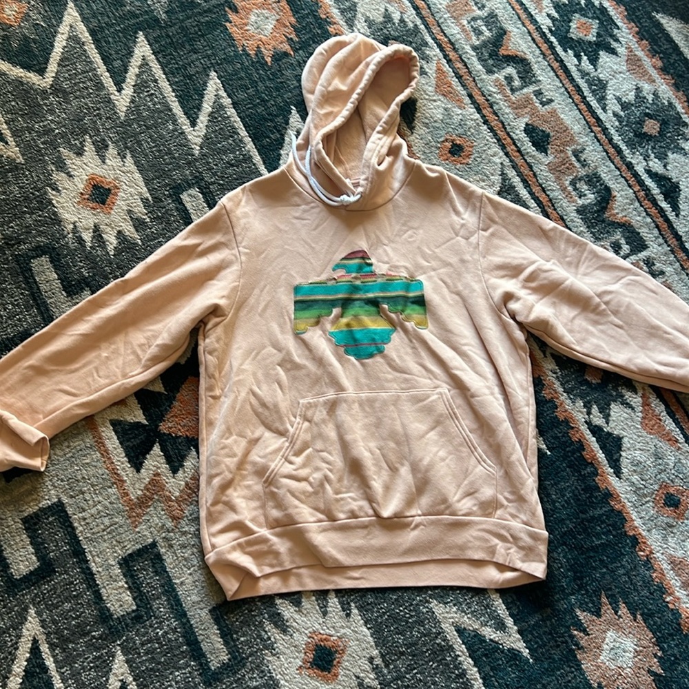 Peach colored jacket.